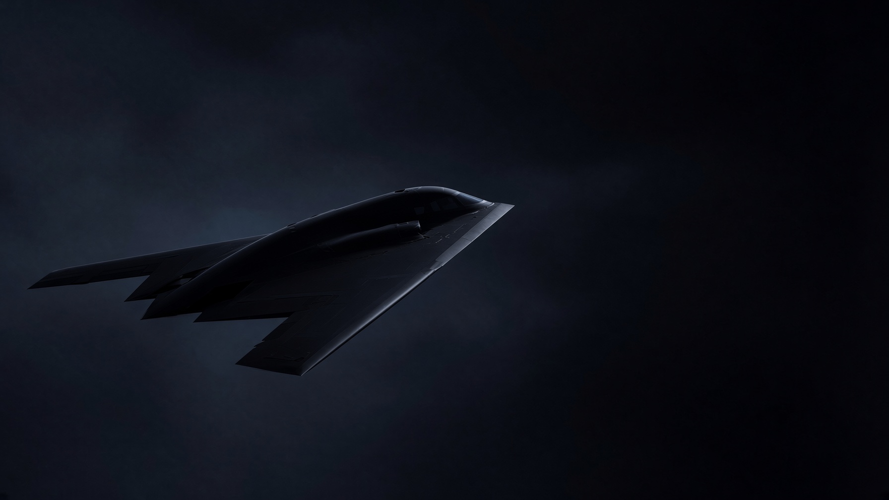 A stealth flying-wing dissolving from a plan drawing into the aircraft
